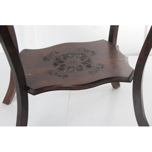 474 - An antique carved occasional table with decorative design. Measuring approx 24x19x28inches.