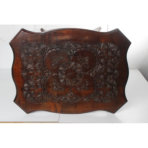 474 - An antique carved occasional table with decorative design. Measuring approx 24x19x28inches.