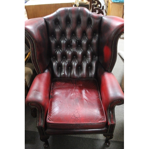 476 - A stunning red leather button back Chesterfield wingback armchair.