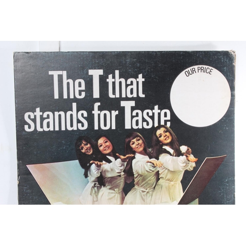 481 - A vintage Ty-Phoo Tea shop advertising card, 'The T that Stands for Taste', measuring 75x47cm.