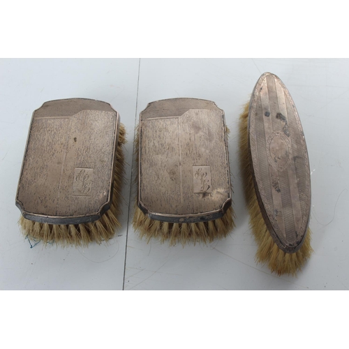 252 - An antique sterling silver backed dressing table brush set.