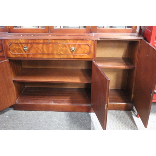 297 - A modern bookcase bureau, with decorative glass doors, measuring 15x78x71inches.