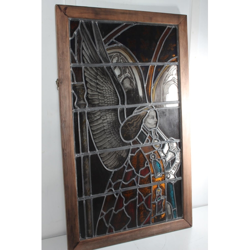 310 - A stunning antique stained leaded glass window panel, with trumpeting angel, measuring 22.5x38inches... 