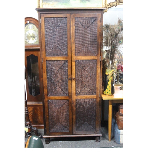 323 - A large modern double rattan wardrobe. 35.5x75.5x23.5inches.