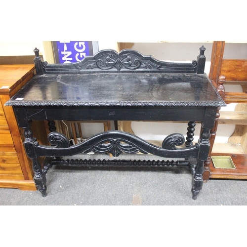 512 - A stunning antique oak ebonised table with gallery back. Measuring approx 48x19.5x38.5inches.