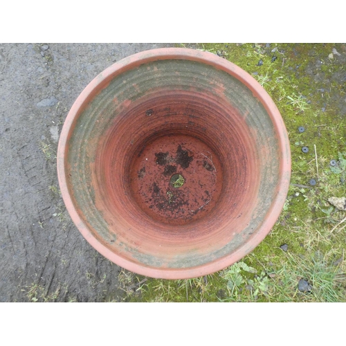 56 - A terracotta planter on metal stand.