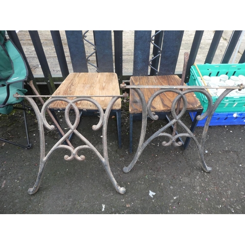 74 - A pair of cast iron table base ends.