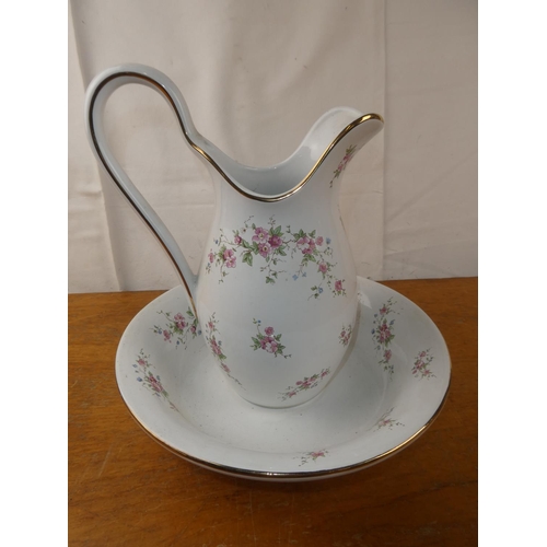 142 - A floral pattern jug and basin set.