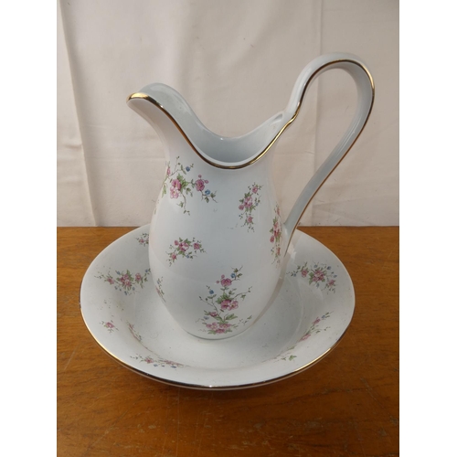 142 - A floral pattern jug and basin set.