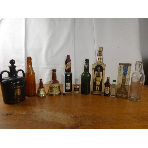 154 - A large assortment of vintage whisky bottles, decanters and more.