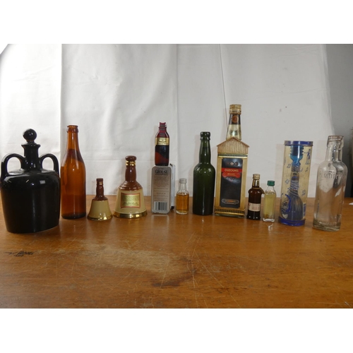 154 - A large assortment of vintage whisky bottles, decanters and more.