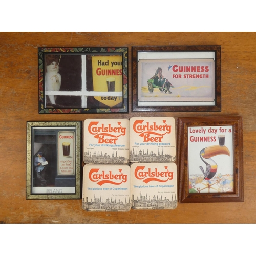 168 - Four Guinness framed advertisements and a large lot of vintage 'Carlsberg' beer mats.