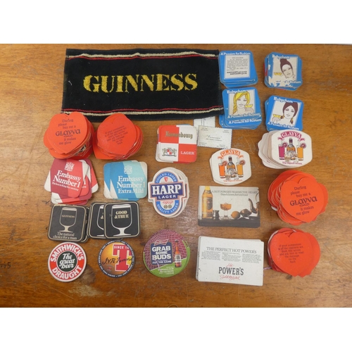 178 - A collection of various vintage beer mats and a Guinness bar towel.