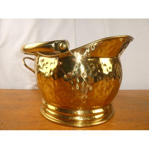 198 - An antique brass helmet coal bucket.