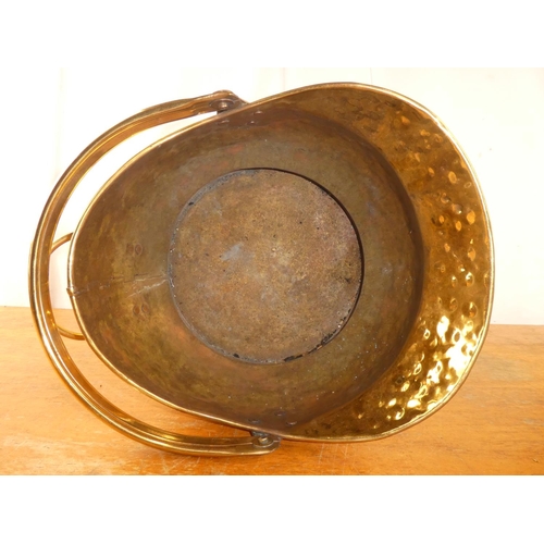 198 - An antique brass helmet coal bucket.