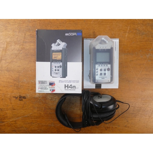 213 - A boxed Zoom H4n handy recorder and earphones .