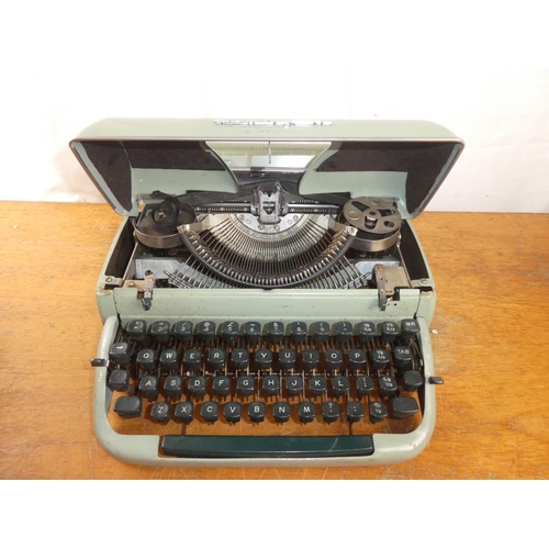 221 - A vintage cased Remington typewriter