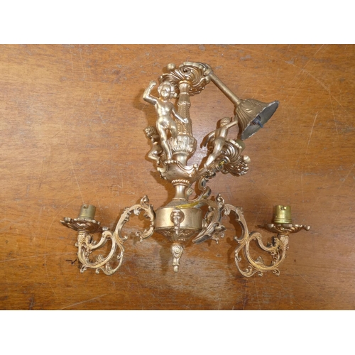 228 - A gilt metal three branch light fitting with decorative scrolls.