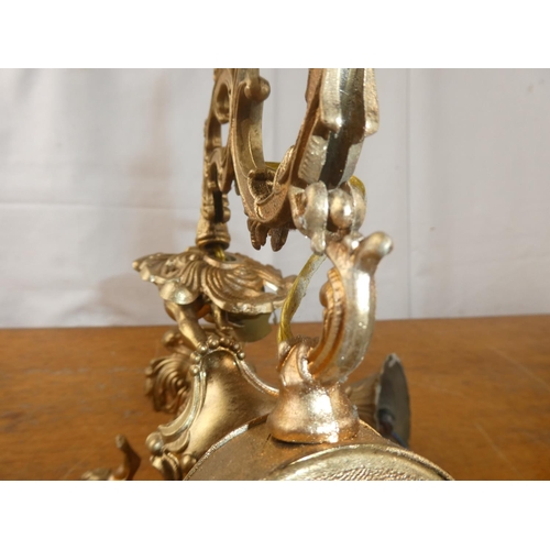 228 - A gilt metal three branch light fitting with decorative scrolls.