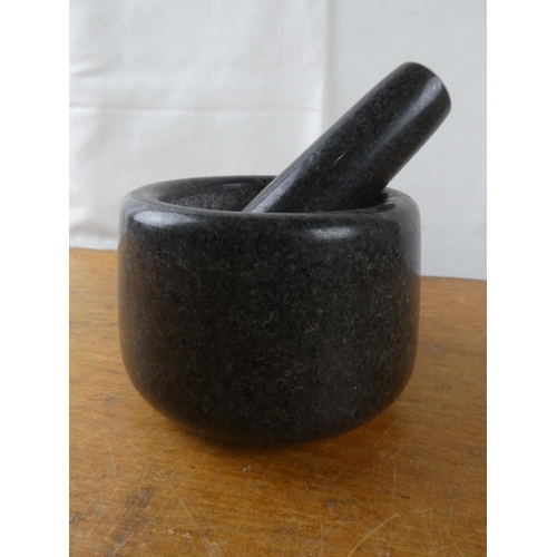 234 - A granite pestle and mortar.