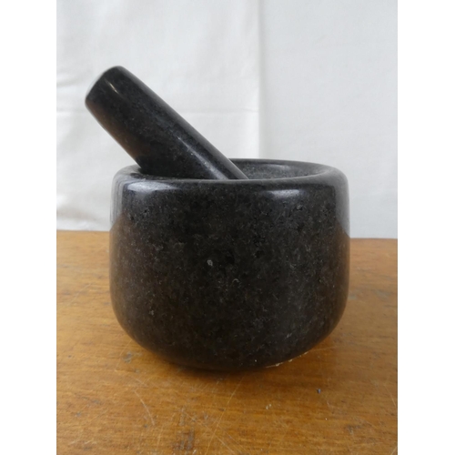 234 - A granite pestle and mortar.