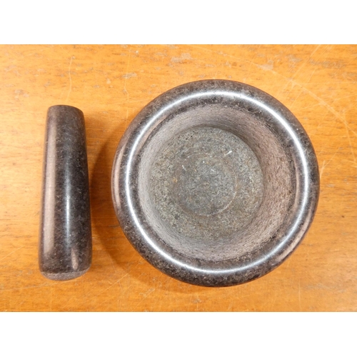 234 - A granite pestle and mortar.