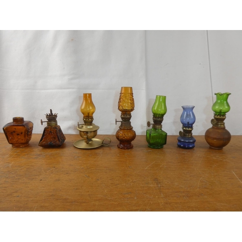 249 - A collection of vintage miniature oil lamps.