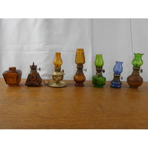 249 - A collection of vintage miniature oil lamps.