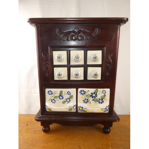 253 - A small wooden table top spice chest with two floral ceramic drawers (a/f).