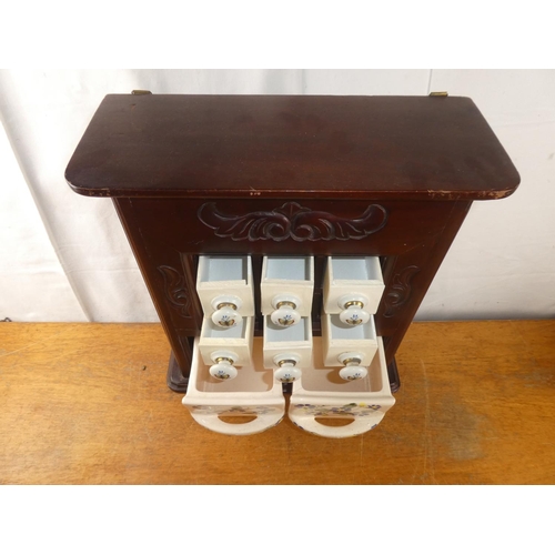 253 - A small wooden table top spice chest with two floral ceramic drawers (a/f).