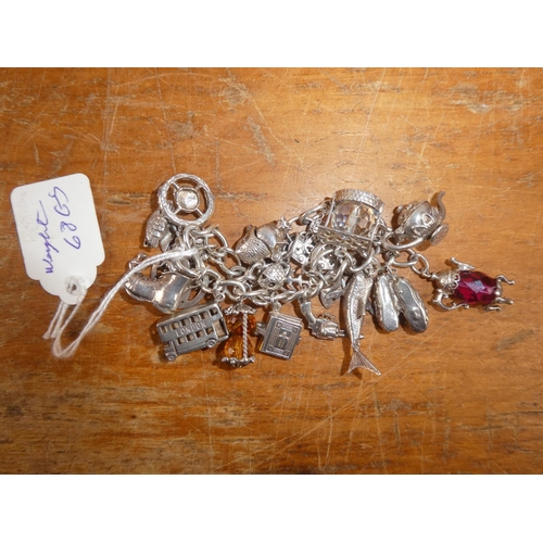 147B - A stunning Silver charm bracelet with an assortment of silver charms, total weight 68g.