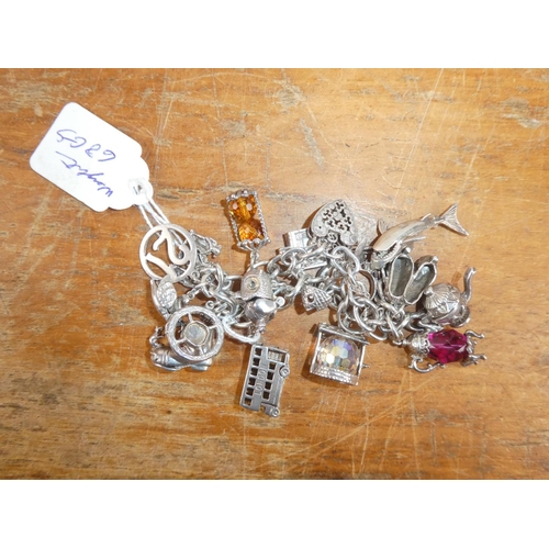 147B - A stunning Silver charm bracelet with an assortment of silver charms, total weight 68g.