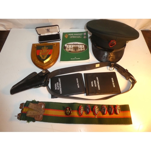 235 - A collection of R.U.C & UDR items to include leather pistol holster, cap, plaque & book etc.