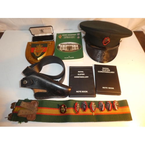 235 - A collection of R.U.C & UDR items to include leather pistol holster, cap, plaque & book etc.