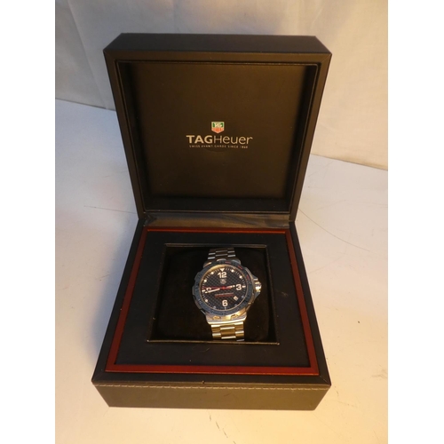 99 - A Tag Heuer carbon fibre watch from the Formula 1 collection, complete with original box and paper.