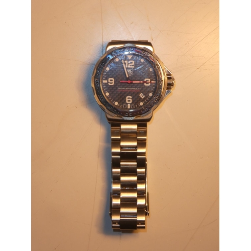 99 - A Tag Heuer carbon fibre watch from the Formula 1 collection, complete with original box and paper.