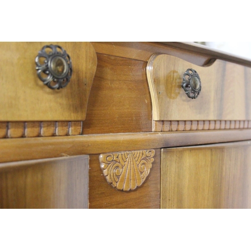 245 - A vintage sideboard with curved panel doors.