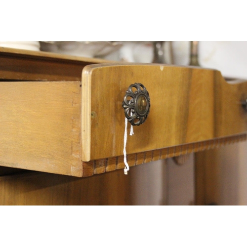 245 - A vintage sideboard with curved panel doors.