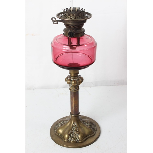 249 - An antique oil lamp with ruby glass font.