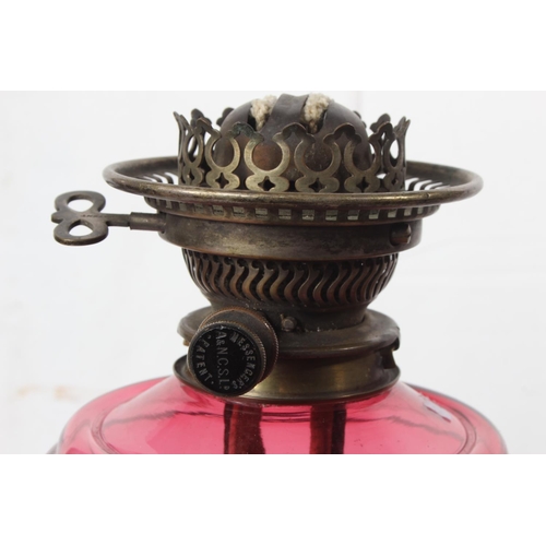 249 - An antique oil lamp with ruby glass font.