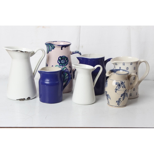 265 - A large lot of blue and white patterned enamel and pottery jugs to include Devon pottery, Ralph Laur... 