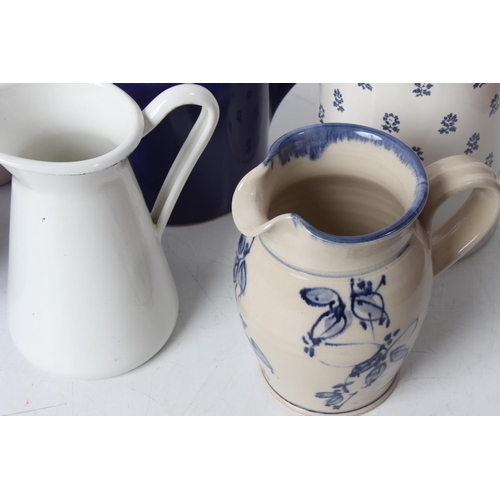 265 - A large lot of blue and white patterned enamel and pottery jugs to include Devon pottery, Ralph Laur... 