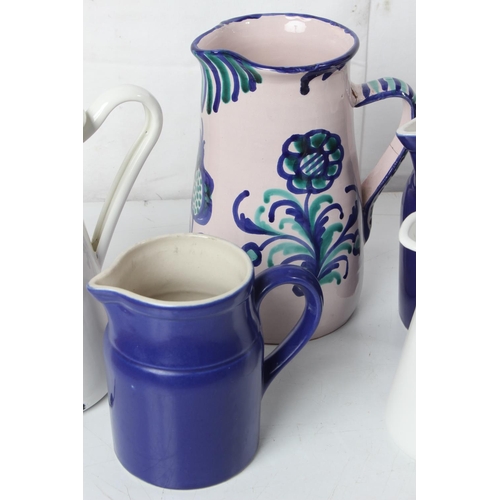 265 - A large lot of blue and white patterned enamel and pottery jugs to include Devon pottery, Ralph Laur... 