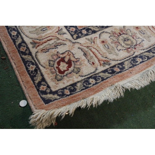 296 - A floral patterned rug, measuring 200cm x 132cm.