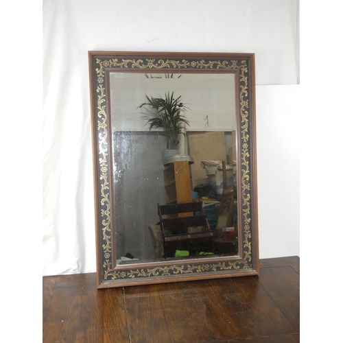 136 - A decorative framed wall mirror.