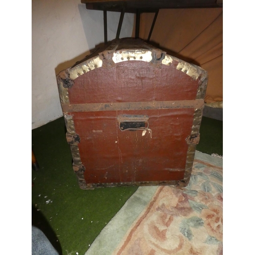 141 - An antique dome shaped trunk with wooden panels.