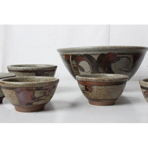 74 - A large vintage studio pottery patterned bowl, a set of five bowls and more.