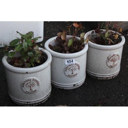 454 - A set of three Heritage Garden Pottery plant pots, measuring 18cm.