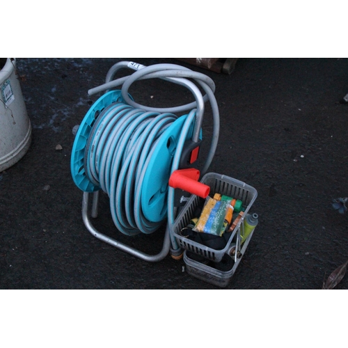 471 - A garden hose and reel and more.