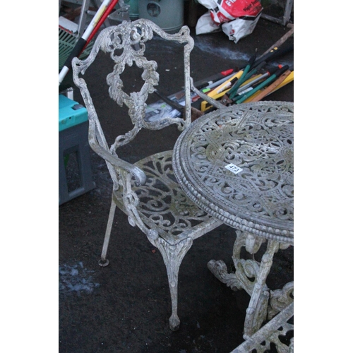 473 - Three piece cast metal garden table and chair set.